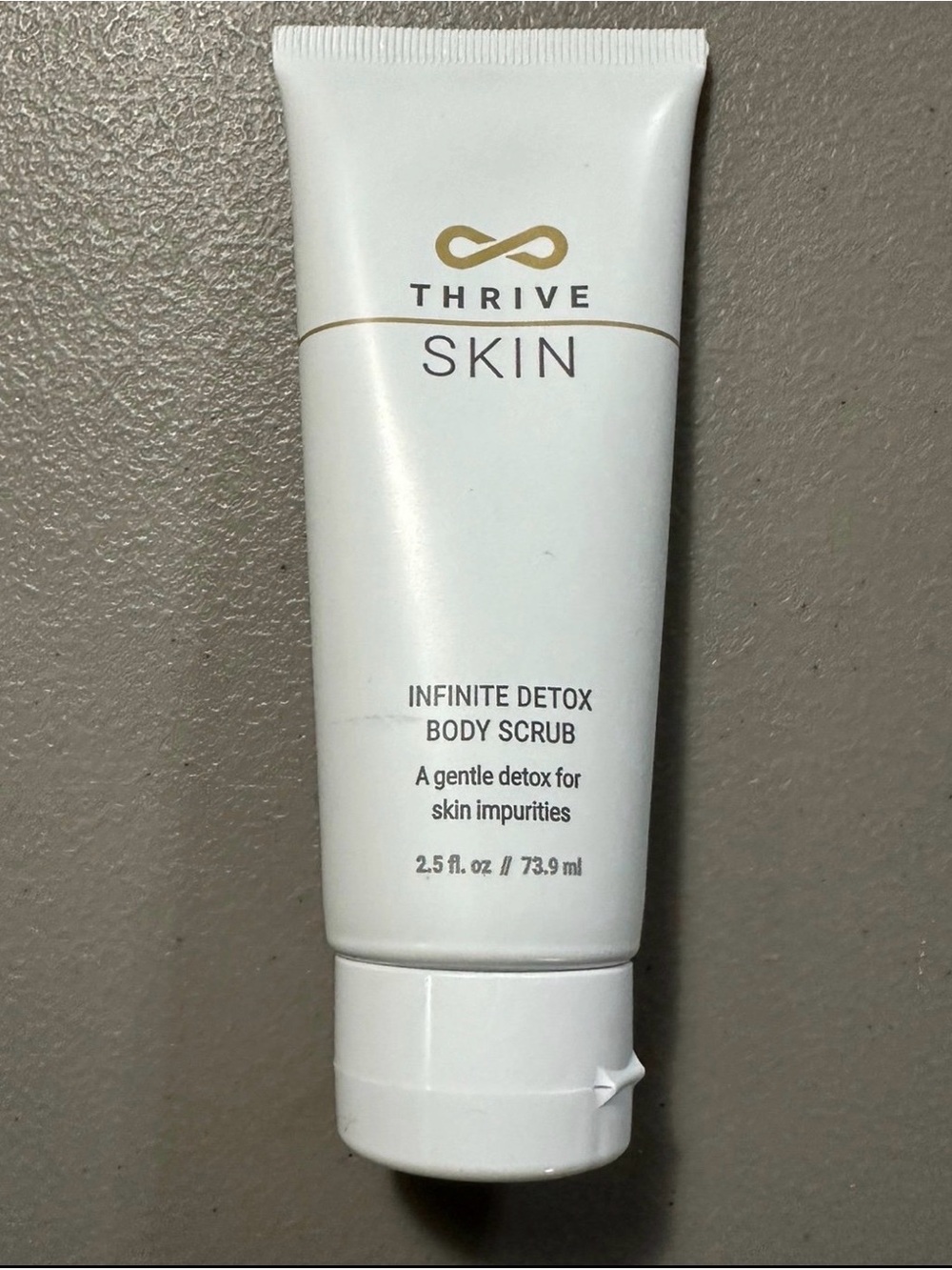 Thrive White Tube Body Scrub with Gold Accents